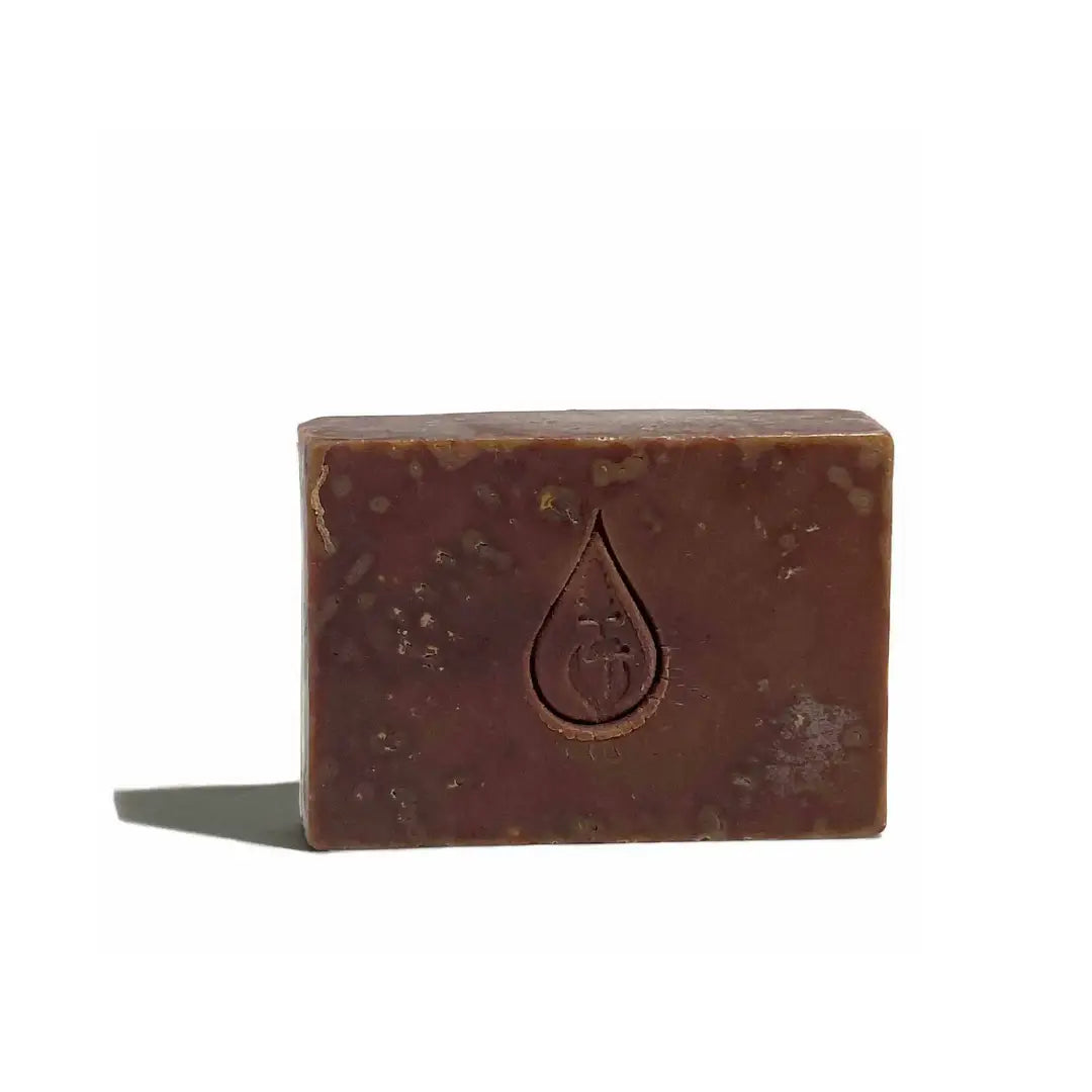By Valenti brown Dark Raw Chocolate bar soap with company's stamped logo on a white background