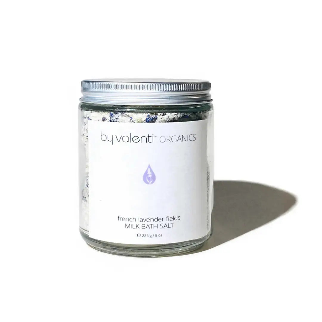 By Valenti glass jar of French lavender milk bath salt with white label on a white background