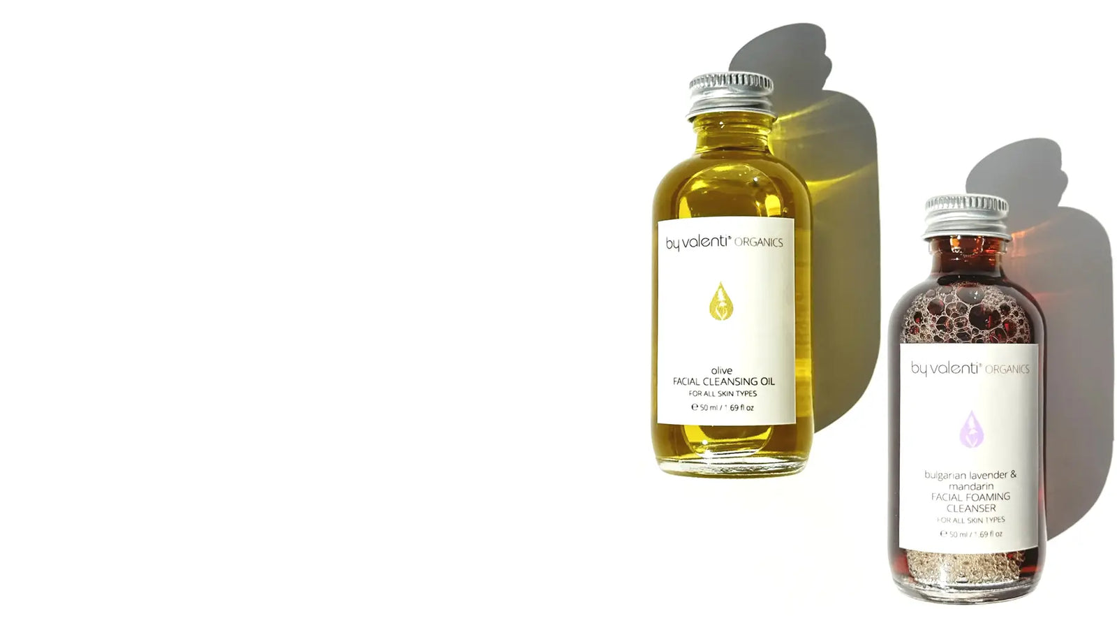 Two bottles of facial cleansing products by By Valenti on a white background