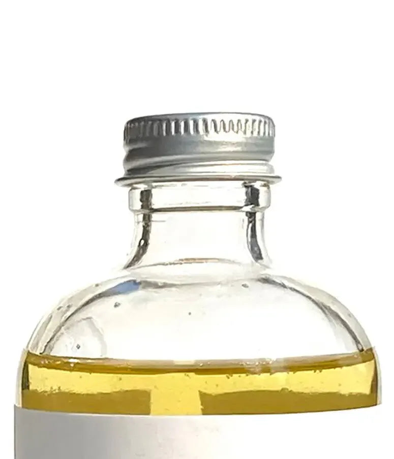 Close up of By Valenti liquid castile soap in a glass bottle
