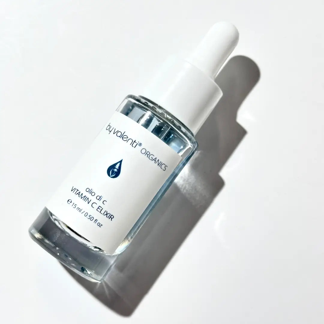 Bottle of By Valenti Organics blue Vitamin C Elixir on a white background