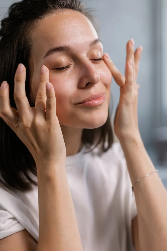 Woman applying serum on face