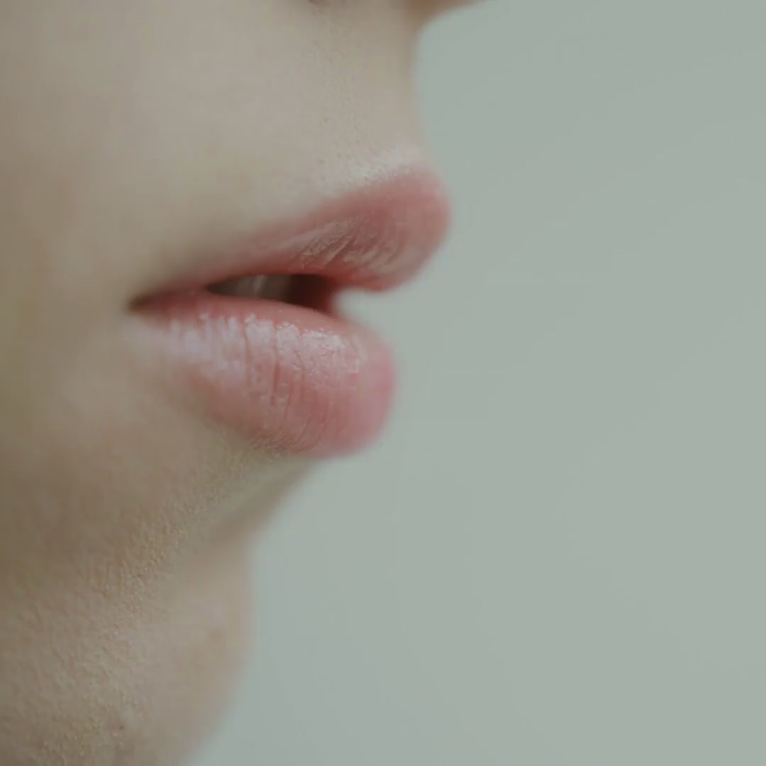 Close up of model's lips during application of By Valenti lip whipped souffle in color oro rosa