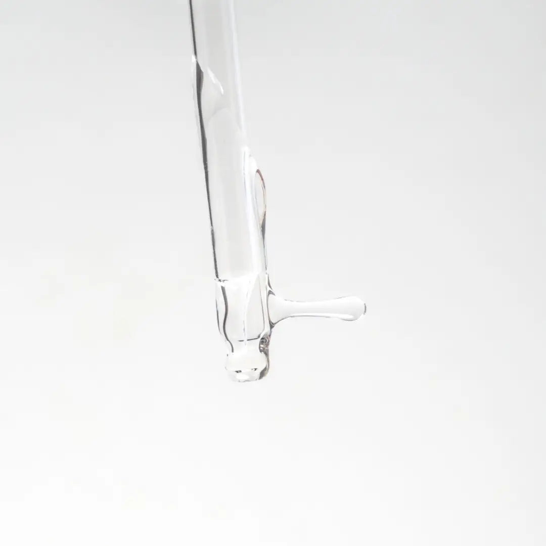 Clear dropper with serum on a white background